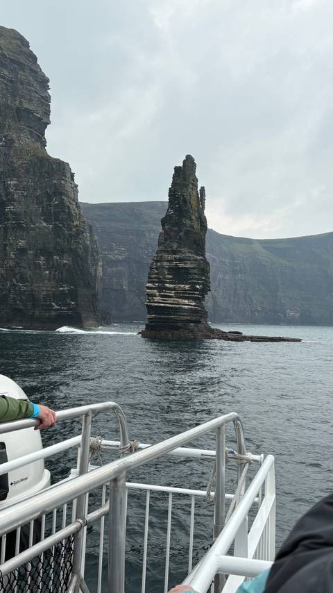       Dramatic sea stack and towering cliffs rising from Atlantic waters off Ireland’s coast.
  
