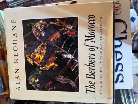       Close-up of a book cover titled 'The Berbers of Morocco' showing an archival photograph of three Berber women.
  