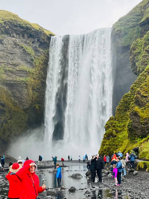       Close-up view of Skogafoss waterfall plunging over mossy cliffs.
  