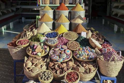       Market stall displays vibrant baskets of spices, dried flowers and herbs neatly arranged in Marrakech.
  