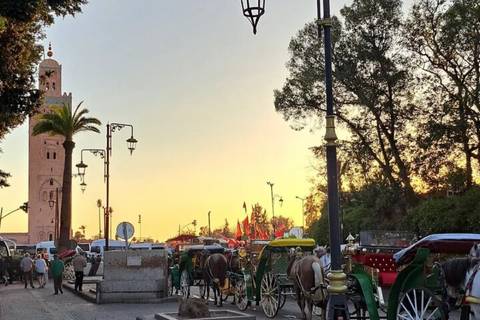       Sunset glow behind the Koutoubia Mosque minaret with horse-drawn carriages and visitors gathered in the square.
  
