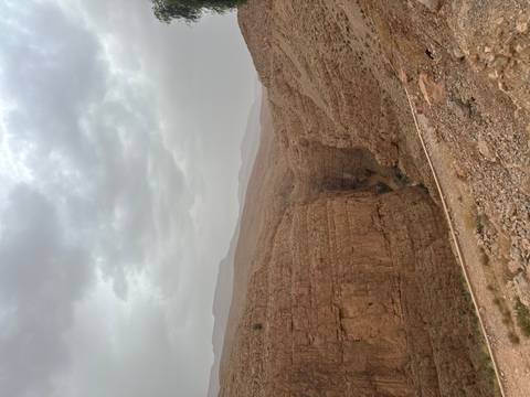       Steep rugged canyon walls under a cloudy sky in the Atlas Mountains
  