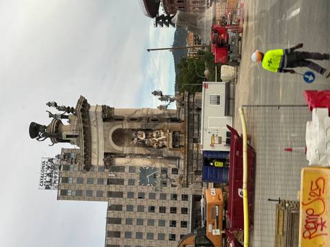       Monument at Plaça d'Espanya Barcelona surrounded by construction barriers and machinery
  
