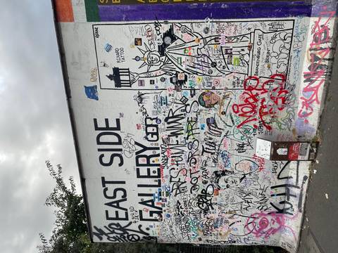       Colourful graffiti-covered section of the Berlin Wall at the East Side Gallery.
  