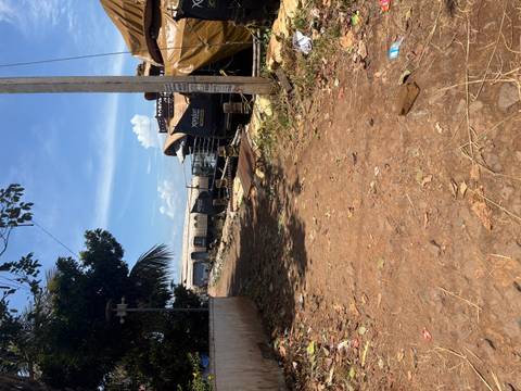       Dusty shore yard with multiple houseboats under repair and scattered debris on a hot day.
  