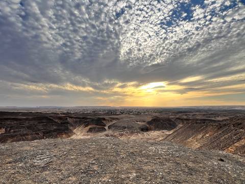       Expansive canyon landscape with dramatic cloud textures and sunbeams breaking through.
  