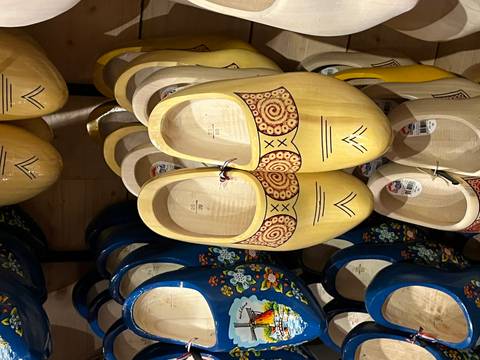       Brightly painted wooden clogs displayed on a shop wall
  