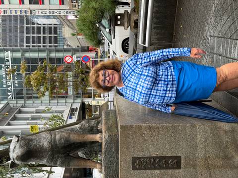       Traveler standing beside the famous Hachiko dog statue at Shibuya crossing.
  
