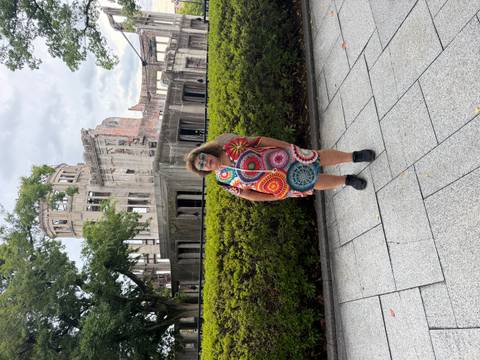       Same traveler in front of the Atomic Bomb Dome on a different angle with hedge foreground.
  