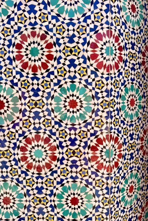       Intricate multicolored zellige tile pattern featuring geometric stars and diamonds.
  