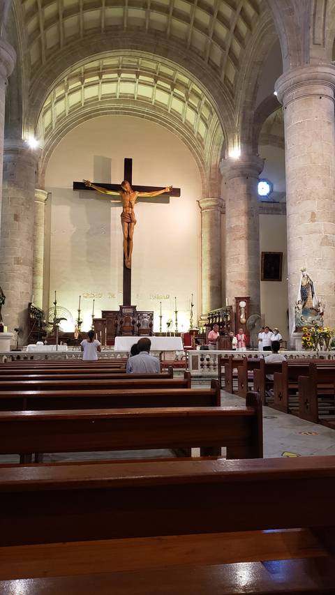 Interior of a church with altar and benches.