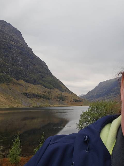       Mountainous landscape with winding roads and greenery.
  