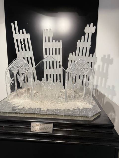 Detailed crystal sculpture in a dark display case.