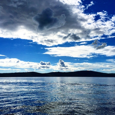 Beautiful ocean view with blue skies and clouds.