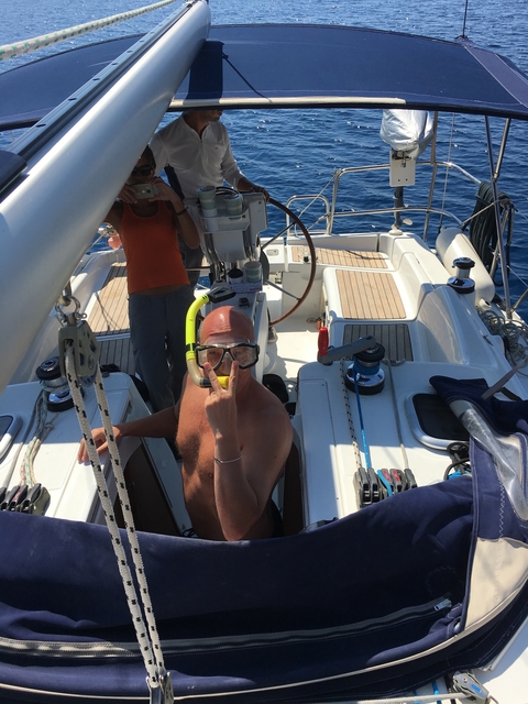       Person with snorkeling gear on a boat.
  