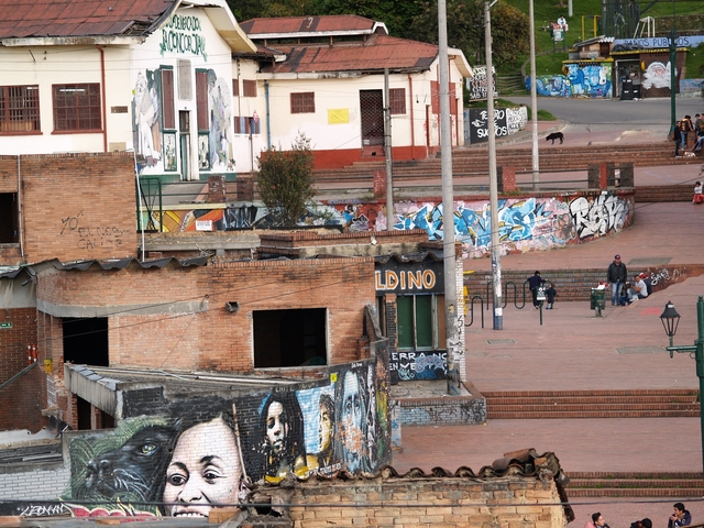 Urban area with graffiti-covered buildings.