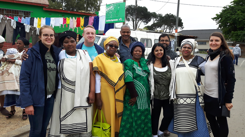 Group of people in traditional attire posing for a photo.