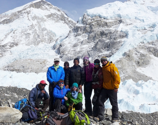       Group of trekkers posing in a mountainous snowy area.
  