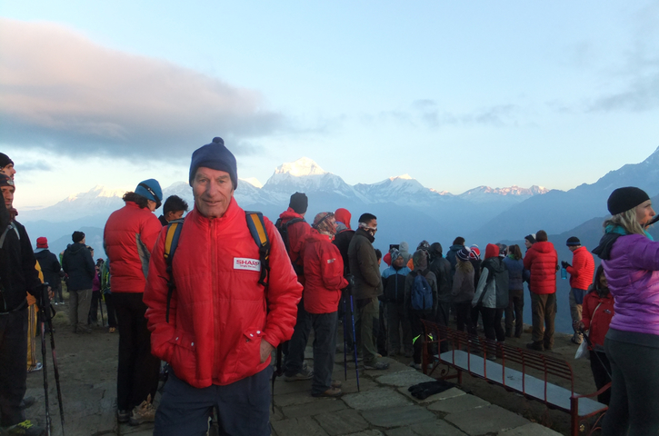 Group of people with mountains in the background.