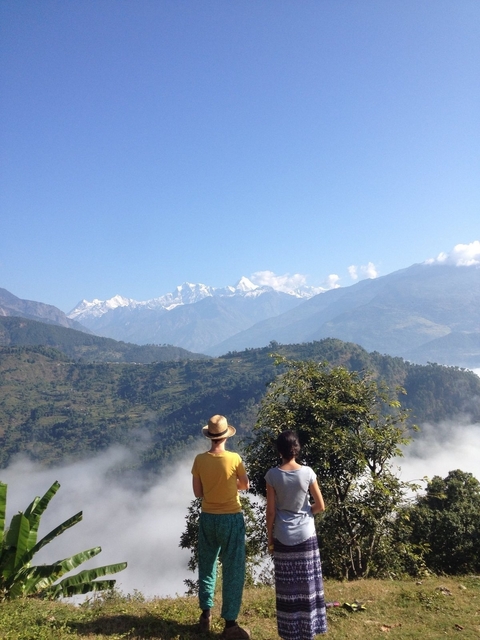       Two people looking at a mountain range.
  