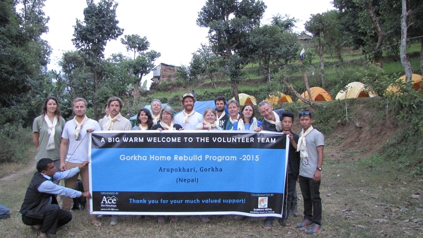       Group photo of volunteers with a banner.
  