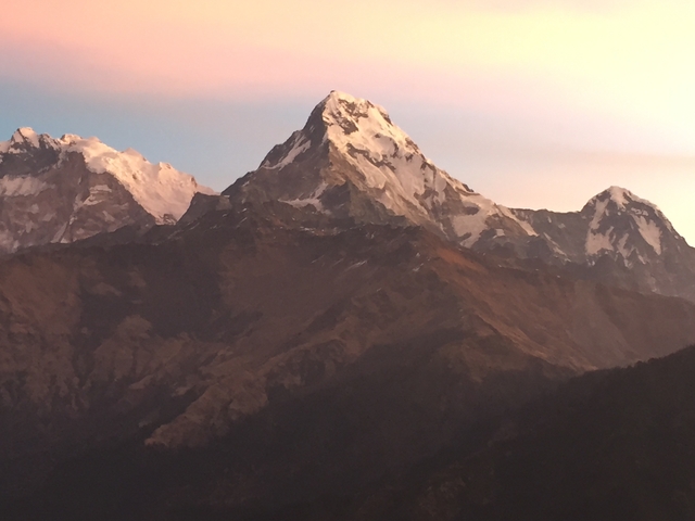 Snow-capped mountain peaks during sunset.