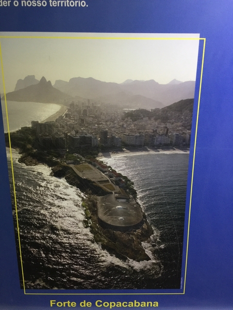 Aerial view of a coastal city, partially obscured by glare.