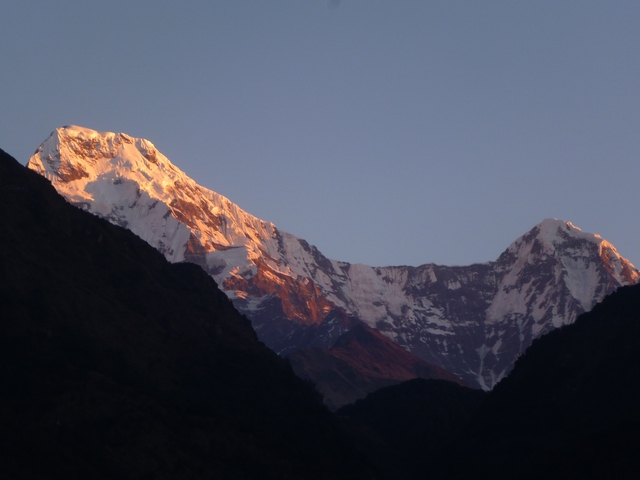       Close-up of snow-capped mountains at sunrise.
  