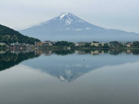 Reflection of a mountain and buildings in a lake.