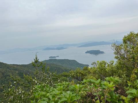      Reflection of islands and sky in a body of water with surrounding nature.
  