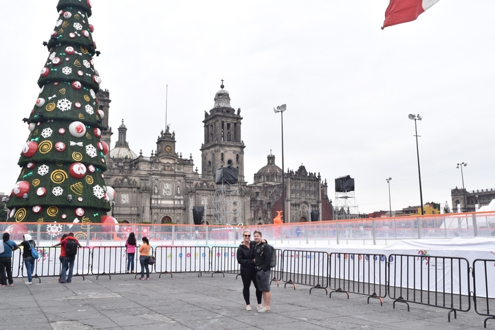 Large Christmas tree and cathedral in a public square.