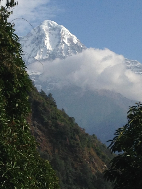 View of a mountain partially obscured by clouds.