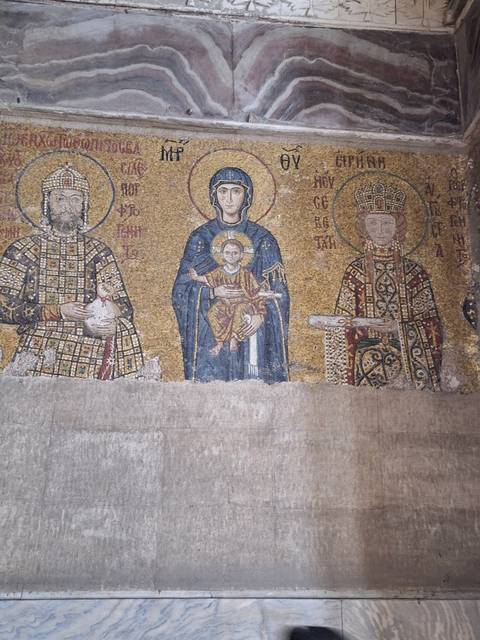 Ancient mosaic art on a wall.