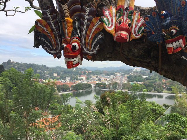 View of a city over a lake with traditional masks.