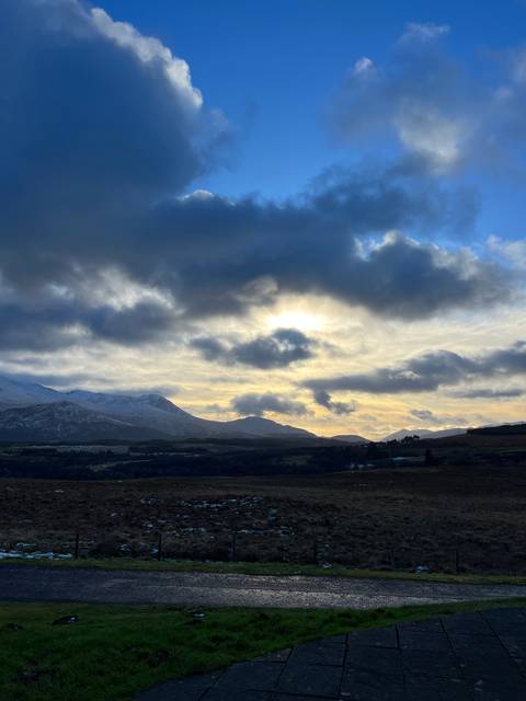 Cloudy sky over a barren landscape.