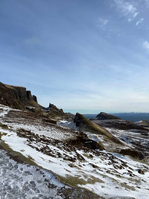 Snowy landscape with rocky terrain.