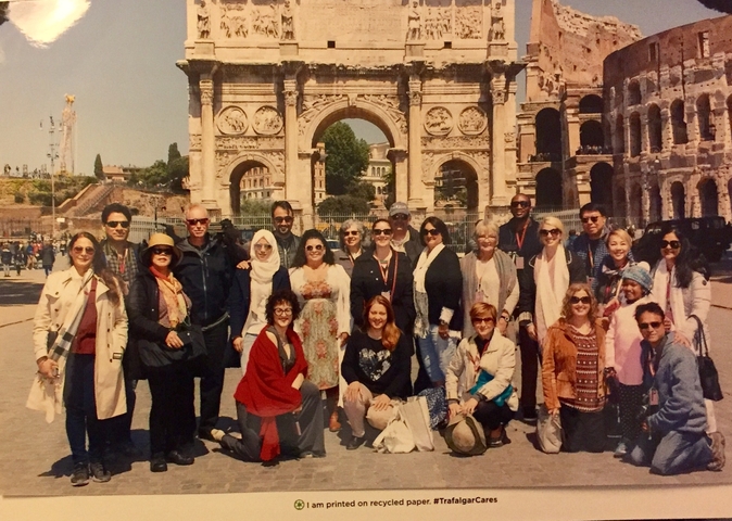 Group photo in front of historic Roman arch.