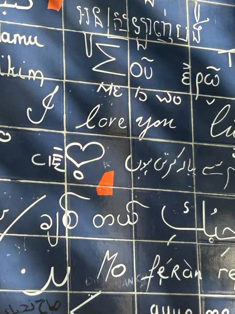 Wall with various languages inscribed.