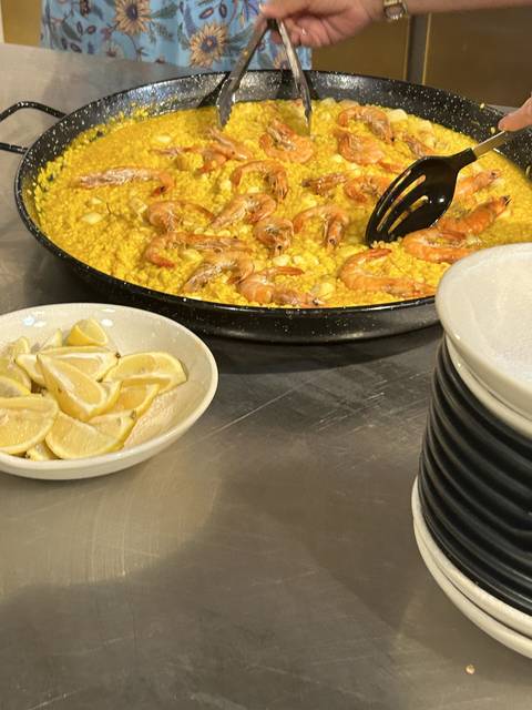       Paella being served at a table.
  
