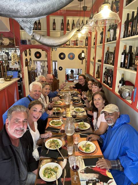       Group of people dining inside a restaurant.
  