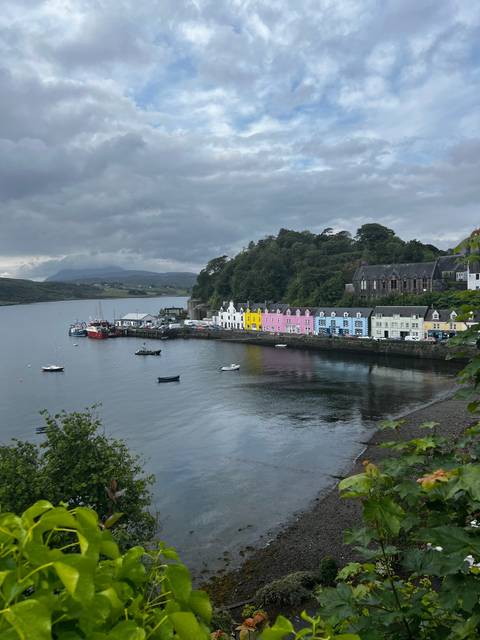 Coastal village with colorful houses and calm waters.