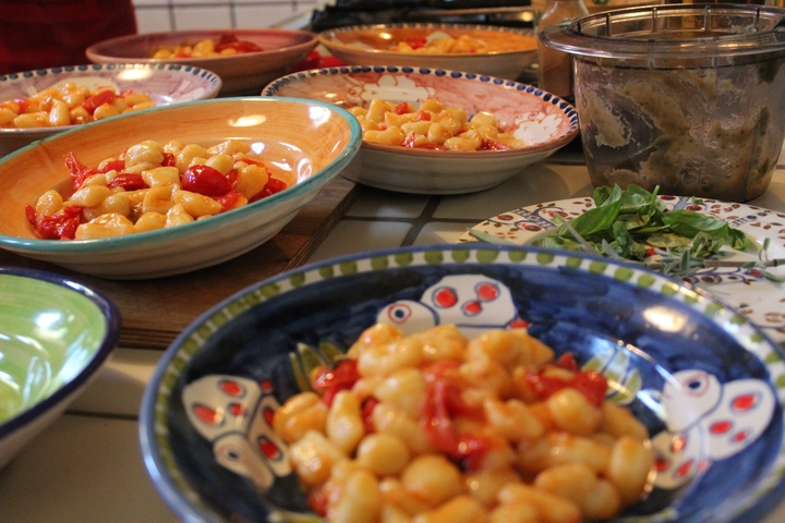 Served dishes of food, possibly pasta, on colorful plates.