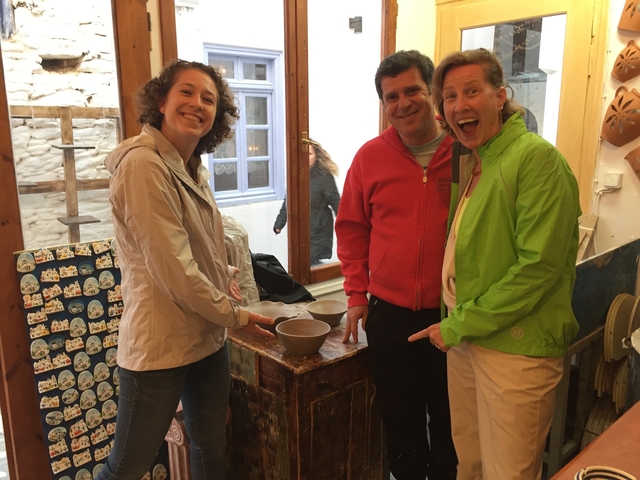 Group of people standing in a local pottery shop.