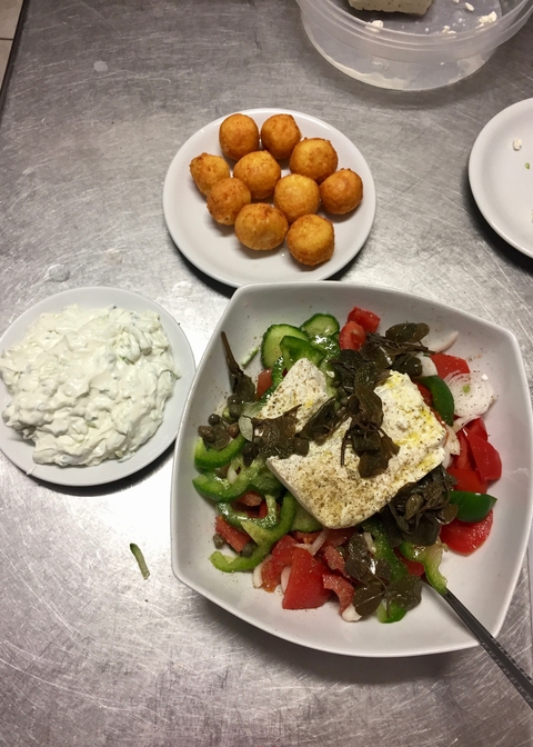 Delicious Greek salad with feta cheese and tzatziki.