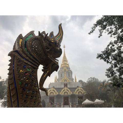       Ornate temple roof and mythical creature at a temple.
  
