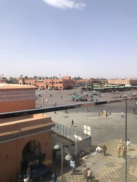       Aerial view of a busy urban plaza with people walking.
  