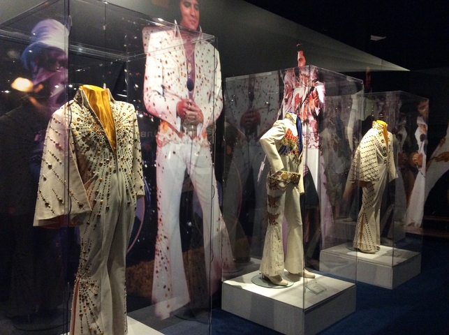       Display of embellished stage costumes in a museum.
  