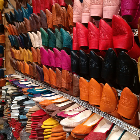Colorful display of traditional Moroccan shoes in a market.