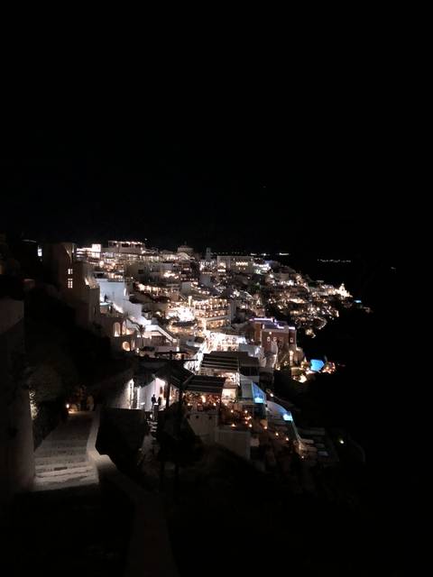 View of illuminated hillside buildings at night.