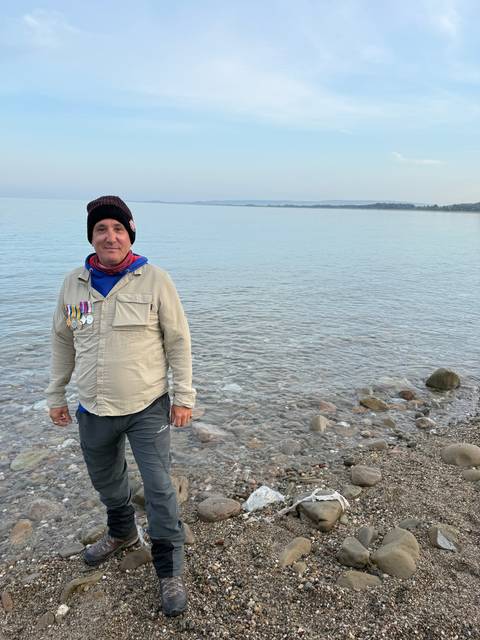 Person standing on a rocky beach.